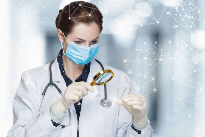 lady doctor holding a magnifying glass and a specimen for seo medical practice