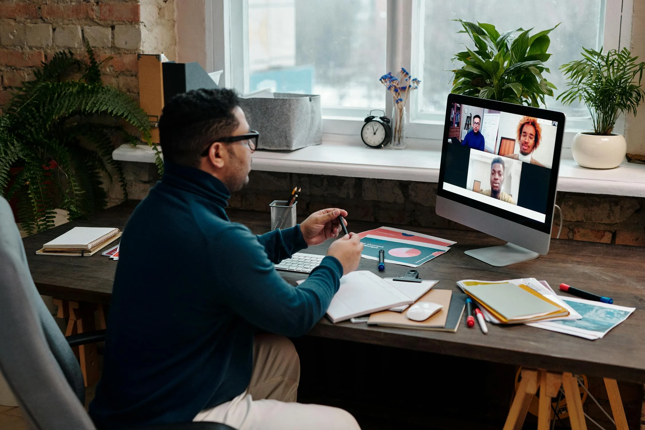 Online Meeting with an SEO team A man at a desk on a video call with SEO Teams